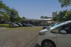 a row of parked cars in a parking lot at Kusatsu Onsen Eidaya in Kusatsu