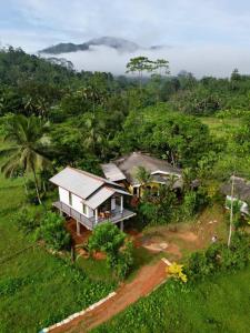 an aerial view of a house in a field at Forest & Fields Sinharaja in Deniyaya