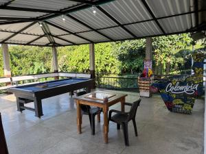 a pool table and two chairs and a ping pong table at Tangara Real Hotel Campestre in Quimbaya