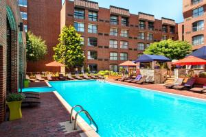 a large swimming pool with chairs and a building at Marriott Providence Downtown in Providence