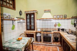 a kitchen with a table and a sink at Casa La Dama de Arucas in Arucas
