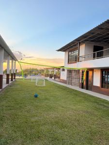 a soccer ball on the grass in the courtyard of a building at Tangara Real Hotel Campestre in Quimbaya