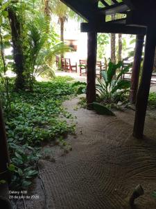 a room with a table and a bunch of plants at Secret Paradise Mahahual in Mahahual