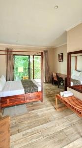 a bedroom with a large bed and a desk at Chinyonga Guesthouse in Limbe +101 photos
