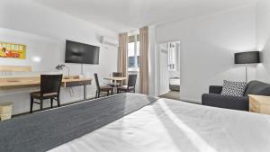 a hotel room with a bed and a living room at The Capital Horsham in Horsham