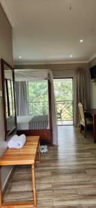 a living room with a bench and a large window at Chinyonga Guesthouse in Limbe