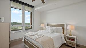 a white bedroom with a large bed and two windows at Hala Tysons in McLean +79 photos
