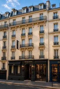a facade of a building with windows at Hotel Maison Lenoir in Paris