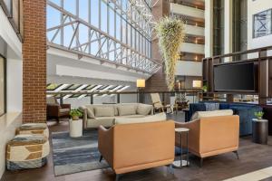 a lobby with couches and a flat screen tv at Salt Lake City Marriott University Park in Salt Lake City