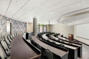 a conference room with rows of chairs and a podium at Salt Lake City Marriott University Park in Salt Lake City