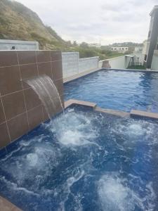 a pool with a water fountain on top of a building at Renata's Depar in Punta Blanca