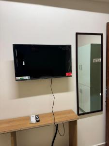 a flat screen tv hanging on a wall at Laya Crest in Chennai