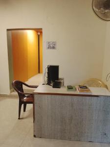an office with a desk with a computer and a chair at Laya Crest in Chennai +7 photos