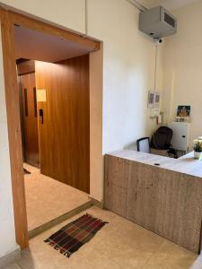 an office with a wooden door and a desk at Laya Crest in Chennai