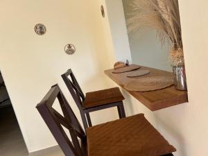 a dinning room with a table and a chair at Katty House in Santa Bárbara de Samaná