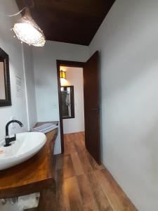 a bathroom with a sink and a mirror at Santa Monica Hospedaria in Praia do Rosa +117 photos