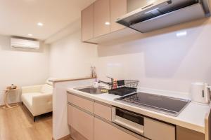 a kitchen with a sink and a stove top oven at New! 3A Home 難波&道頓堀直通 2LDK一棟貸切 最大4名 in Osaka