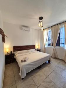 a bedroom with a bed with two shoes on it at Sicarú, La Punta - Puerto Escondido in Brisas de Zicatela