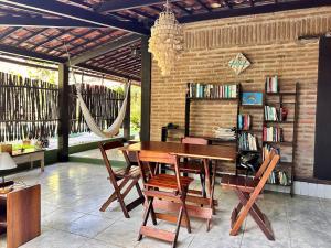 a dining room with a wooden table and chairs at Pousada Ibirapuera in Jericoacoara