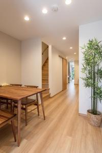 a dining room with a table and a potted plant at New! 3A Home 難波&道頓堀直通 2LDK一棟貸切 最大4名 in Osaka