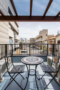 a patio with a table and chairs on a balcony at New! 3A Home 難波&道頓堀直通 2LDK一棟貸切 最大4名 in Osaka +47 photos