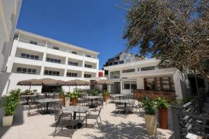 a patio with tables and chairs in front of a building at TRYP by Wyndham Didim in Didim