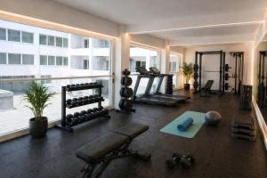 a fitness room with a gym with a large window at TRYP by Wyndham Didim in Didim