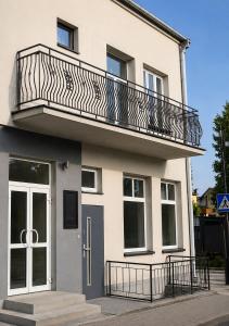 a building with a balcony on top of it at WlodawaSpot in Włodawa