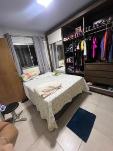 a bedroom with a bed and a walk in closet at Vieira House in Brasília