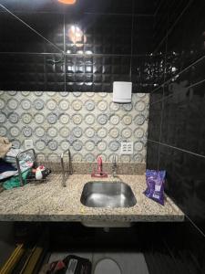 a kitchen counter with a sink in a room at Vieira House in Brasília +6 photos