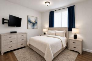 a bedroom with a bed and a flat screen tv at First Tracks Cabin in Eden +1 photo