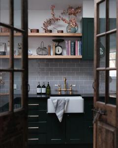 a kitchen with green cabinets and a sink at Raffah House in Oatlands +44 photos