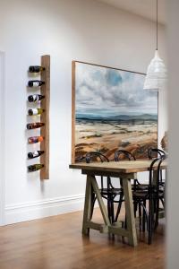 a dining room with a table with chairs and a painting at Raffah House in Oatlands