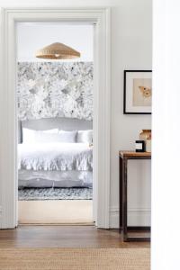 a bedroom with a bed through a doorway at Raffah House in Oatlands