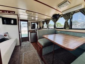 a dining area of an rv with a wooden table at Buffalo's River Den II - Easy Rider in Buffalo