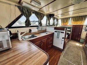 a kitchen in an rv with a refrigerator and a sink at Buffalo's River Den II - Easy Rider in Buffalo +23 photos
