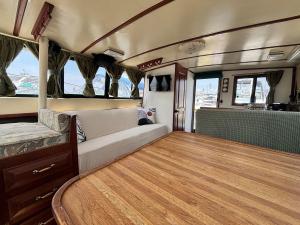 an interior of an rv with a couch and windows at Buffalo's River Den II - Easy Rider in Buffalo