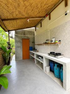 a kitchen with a white counter and a red door at Lunara Villas in El Nido