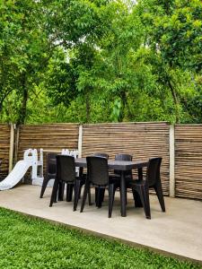 a table and chairs on a patio with a slide at Lunara Villas in El Nido +6 photos