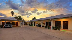a building with cars parked in a parking lot at Western Downs Motor Inn in Miles