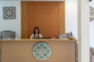 a woman sitting at a counter in an office at Bali Residence Villa in Uluwatu +70 photos