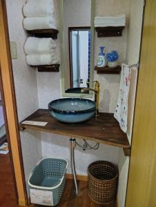 a bathroom with a sink and a mirror and towels at ただいまtadaima in Yahata +85 photos