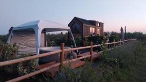 a tent in front of a house in a field at Monteleone X by Tiny Away in Battipaglia