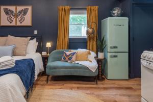 a bedroom with a bed and a chair and a dresser at Soft Launch Deal Butterfly Bungalow Studio in Saugerties