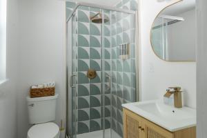 a bathroom with a shower and a toilet and a sink at Soft Launch Deal Butterfly Bungalow Studio in Saugerties +26 photos