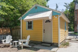 a yellow shed with two chairs and a table at Soft Launch Deal Butterfly Bungalow Studio in Saugerties