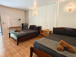 a room with two beds and a couch in it at Ban Tai Resort in Ban Tai