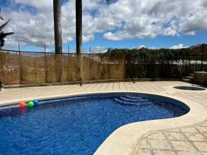 a swimming pool in a backyard with a fence at Casa Roraima in San Antonio
