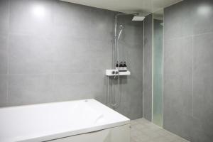 a bathroom with a shower and a white toilet at 진해프렌치코드호텔 in Chinhae +34 photos