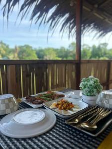 a table topped with plates of food on a table at RM's Tourist Inn in Carmen